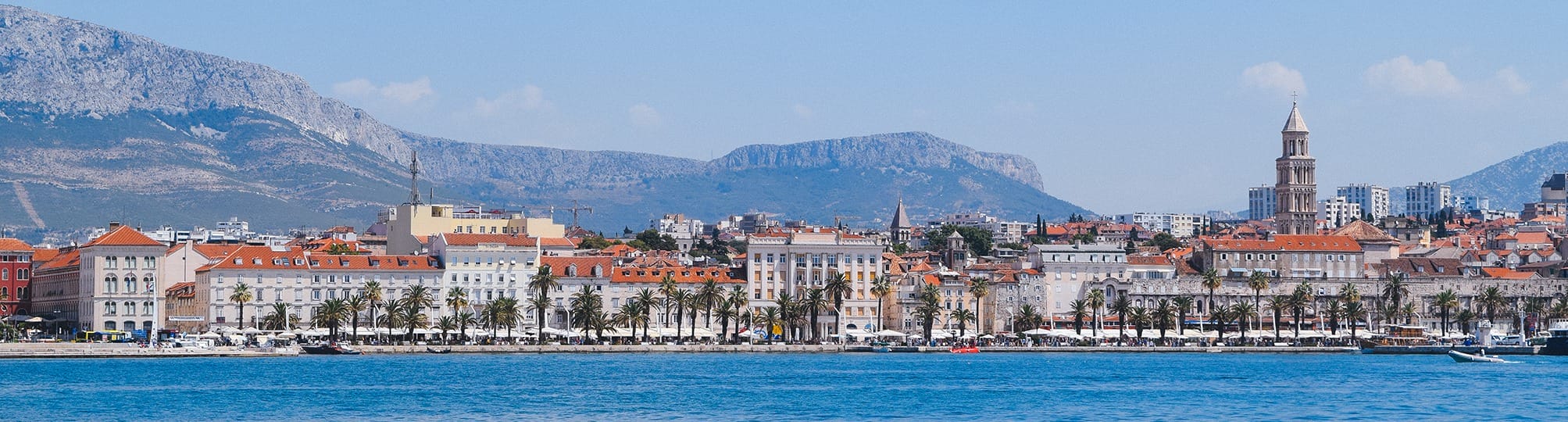 Vibrant view of the Split sailing route in Croatia – A yacht sailing through the picturesque waters of the Adriatic Sea, with the historic city of Split and its stunning coastal landscape in the background.